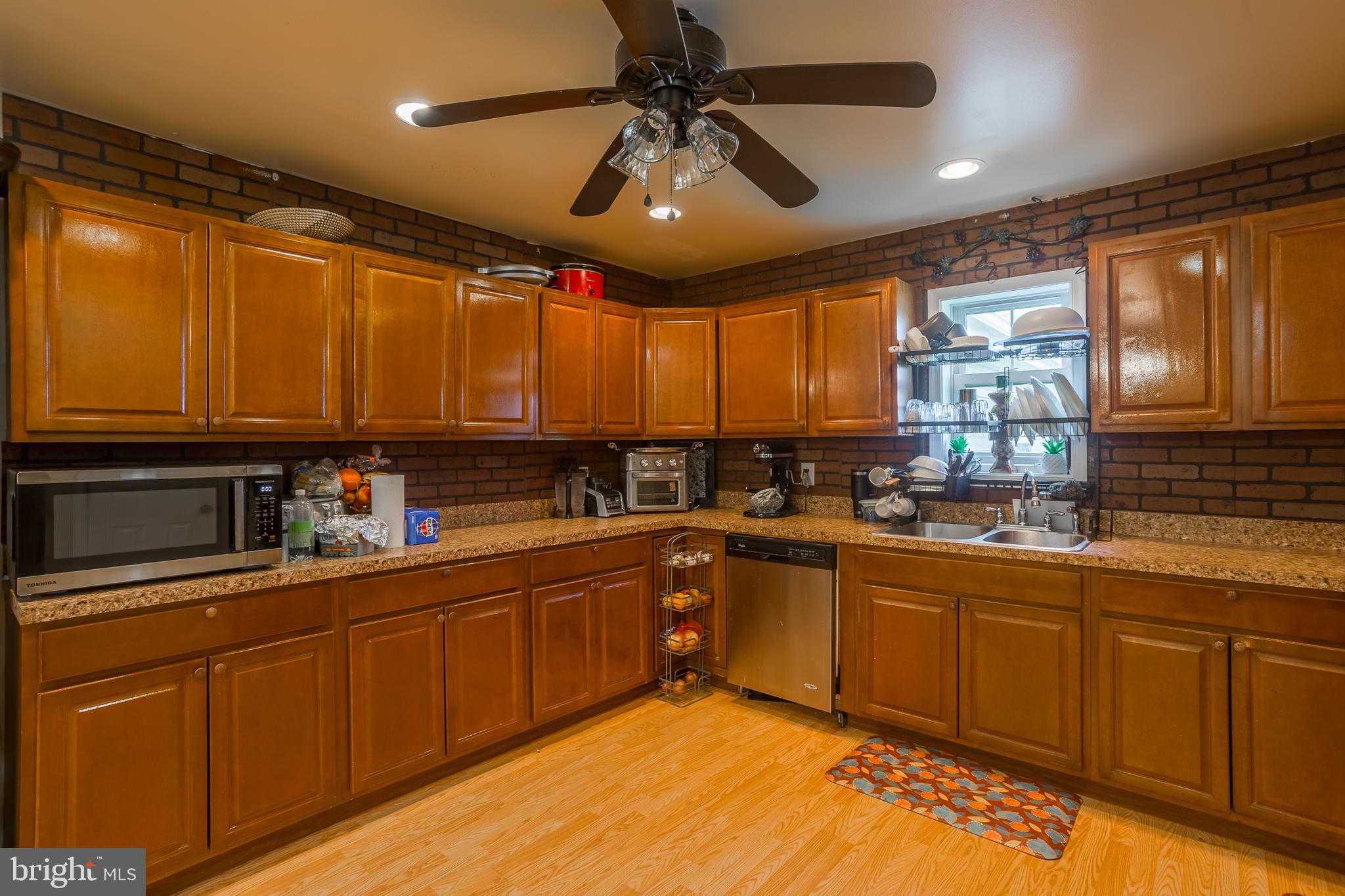 6629 Bowden Road Newark, MD 21841 - Photo 43 of 63 a kitchen with stainless steel appliances granite countertop sink stove and cabinets