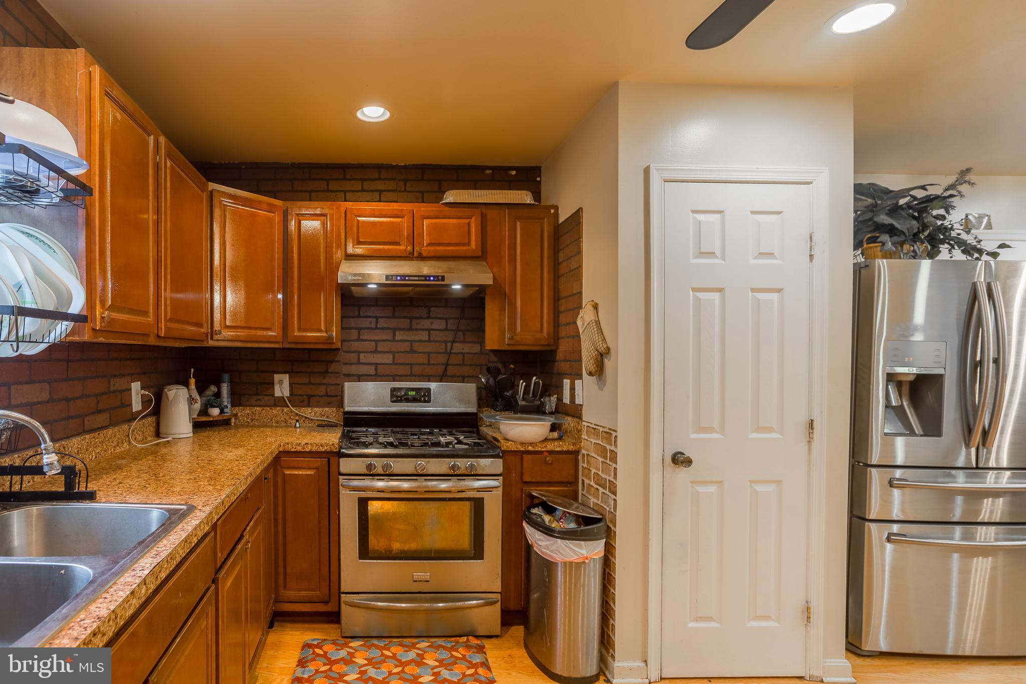 6629 Bowden Road Newark, MD 21841 - Photo 44 of 63 a kitchen with stainless steel appliances granite countertop a refrigerator and a sink
