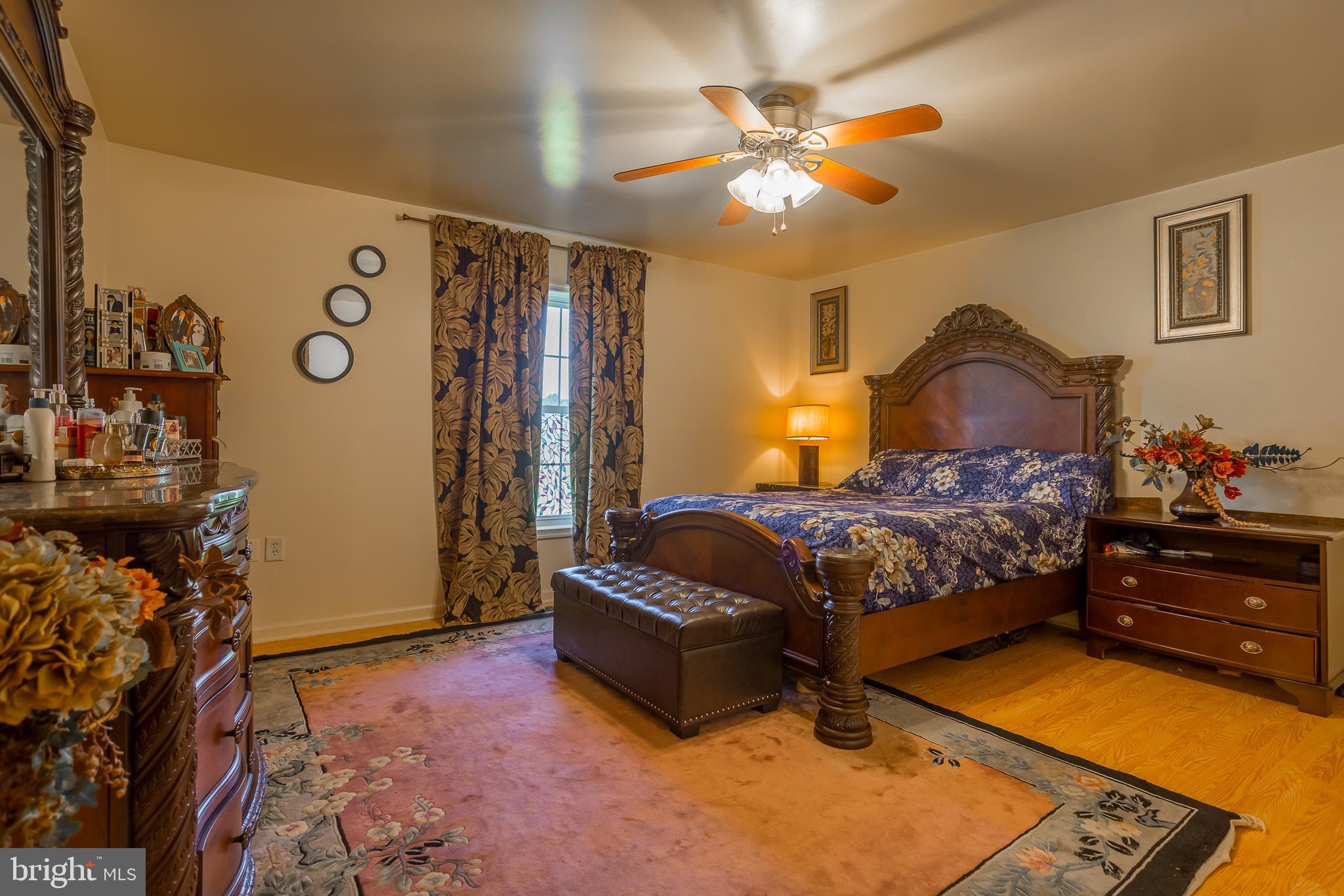 6629 Bowden Road Newark, MD 21841 - Photo 45 of 63 a bedroom with a bed and a chandelier