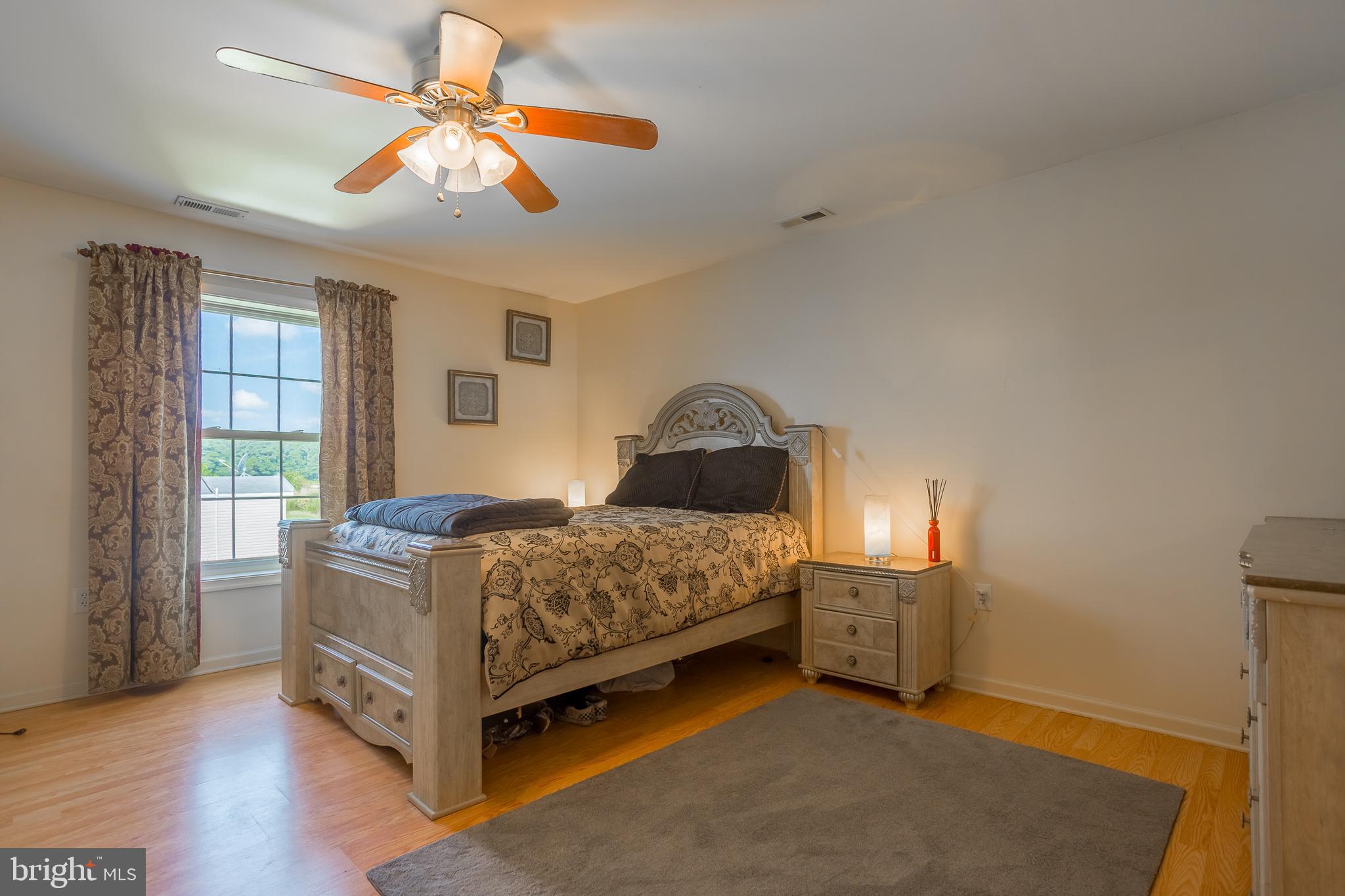 6629 Bowden Road Newark, MD 21841 - Photo 62 of 63 a bedroom with a bed and a chandelier