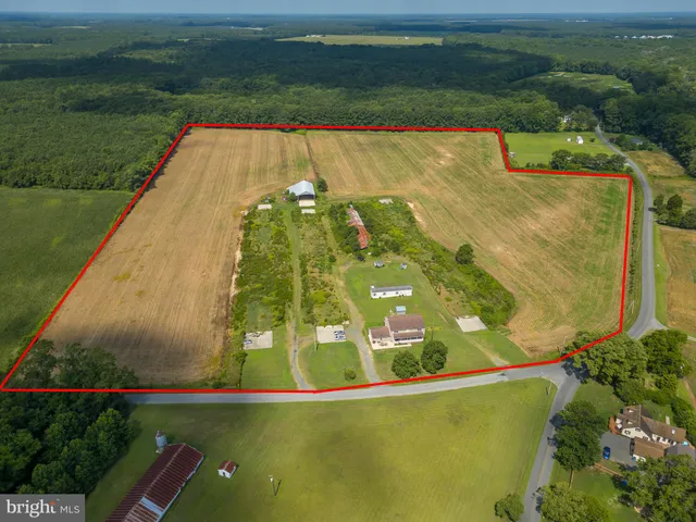 a view of a swimming pool with a yard and outdoor seating