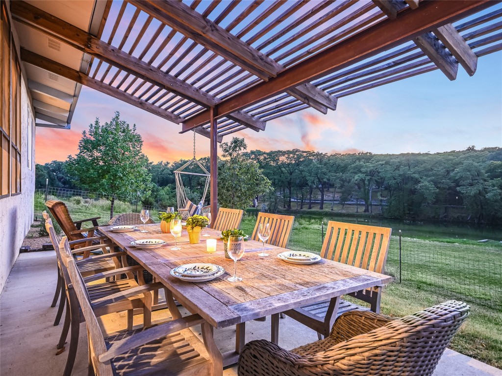a view of a patio with a table chairs and a backyard