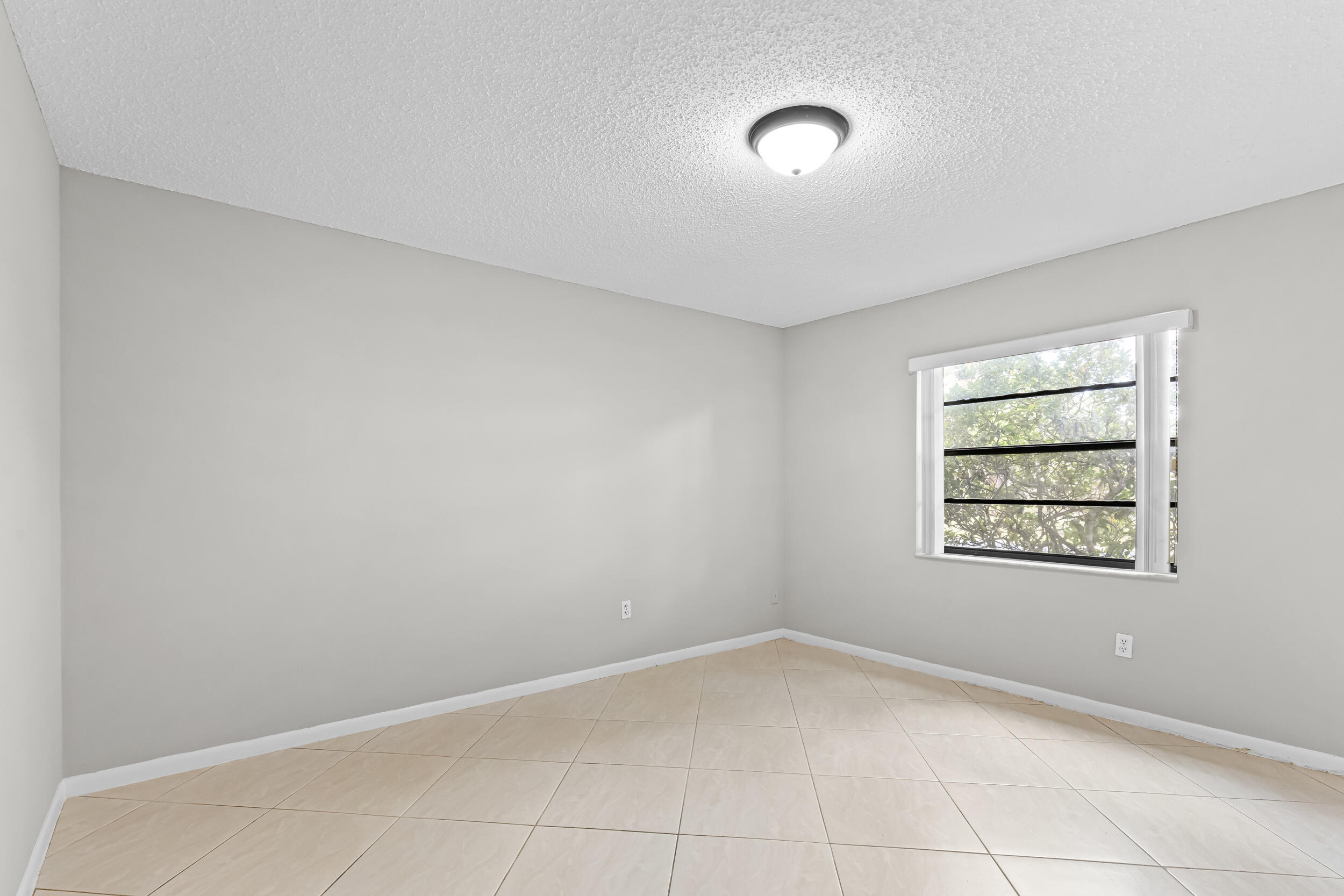 9270 Vista Del Lago, Unit E27 Boca Raton, FL 33428 - Photo 15 of 22 an empty room with a window