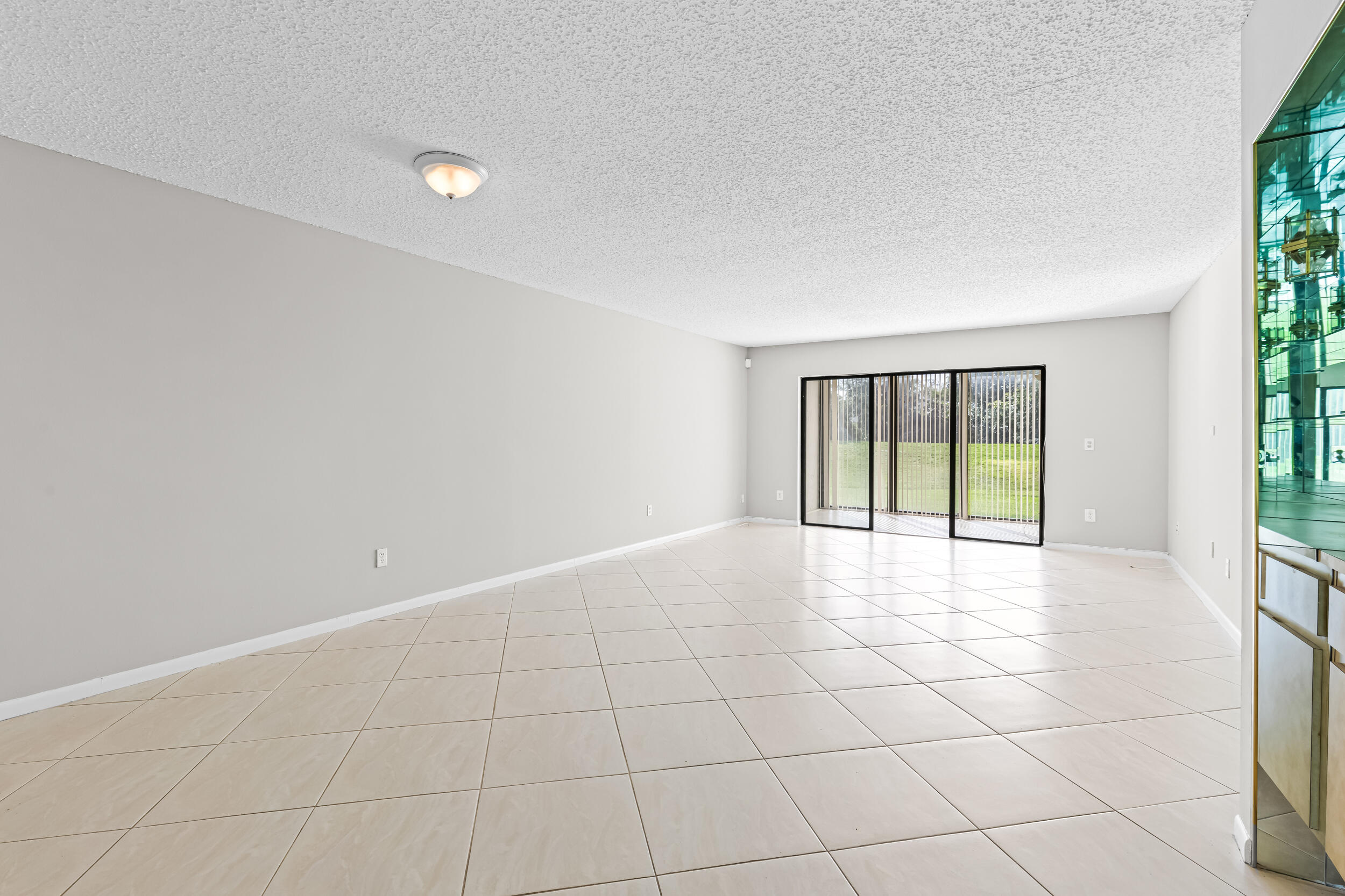 9270 Vista Del Lago, Unit E27 Boca Raton, FL 33428 - Photo 4 of 22 a view of an empty room with a window
