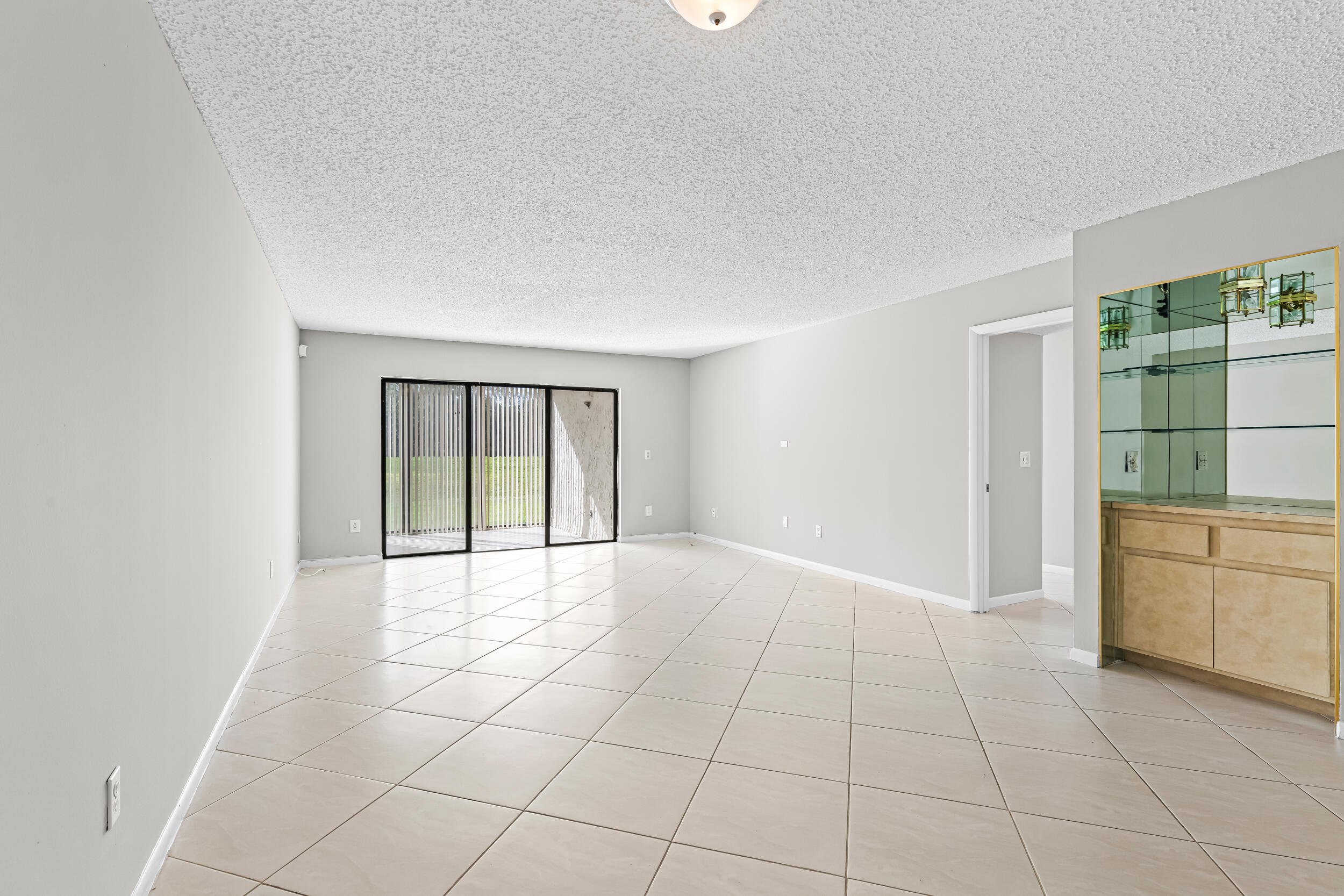 9270 Vista Del Lago, Unit E27 Boca Raton, FL 33428 - Photo 5 of 22 a view of an empty room with a window