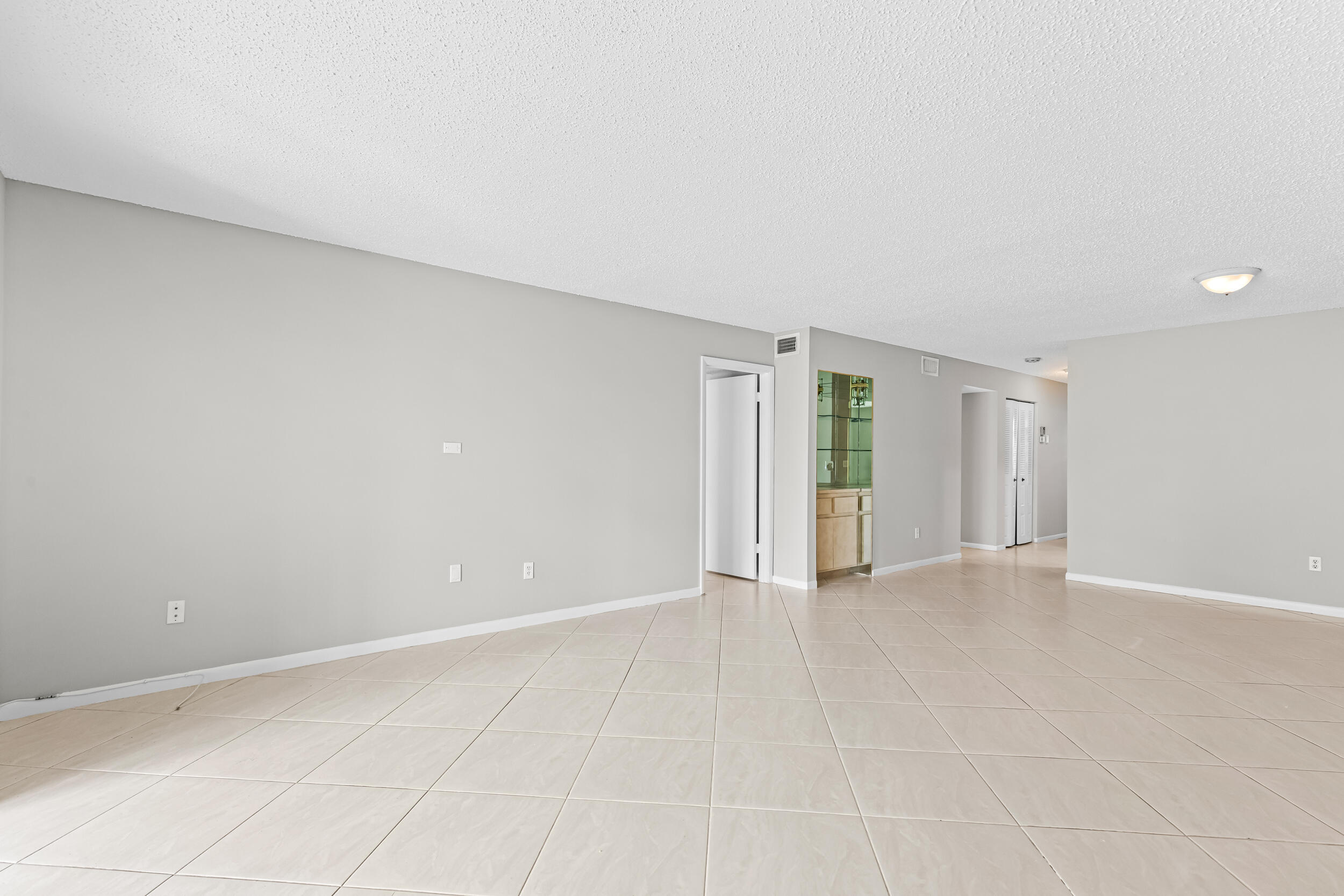 9270 Vista Del Lago, Unit E27 Boca Raton, FL 33428 - Photo 6 of 22 an empty room with an entryway