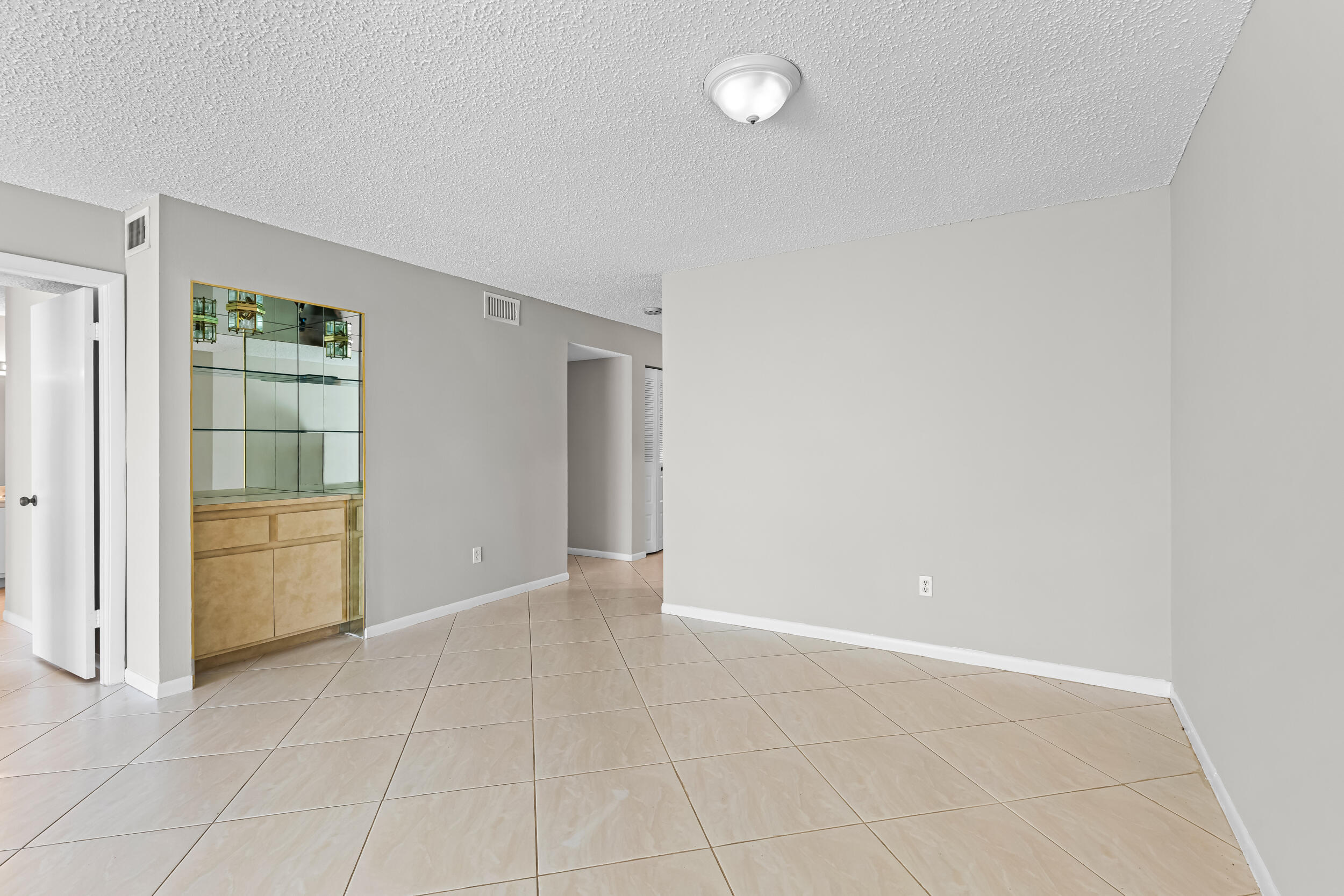 9270 Vista Del Lago, Unit E27 Boca Raton, FL 33428 - Photo 8 of 22 an empty room with closet and windows
