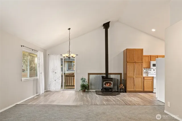 a view of a kitchen with refrigerator and windows