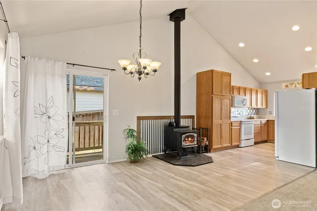 a view of a kitchen with a refrigerator a oven a sink and a refrigerator