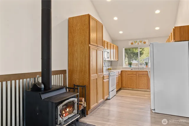 a kitchen with a refrigerator and a stove top oven
