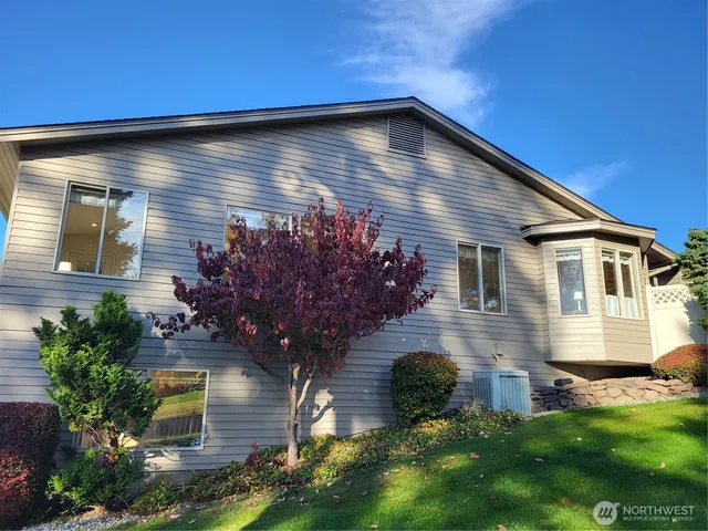 a front view of house with yard and outdoor seating
