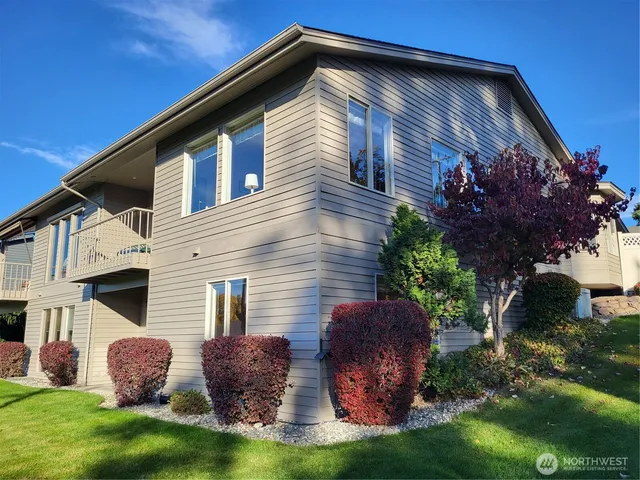 a front view of a house with a yard and a garage
