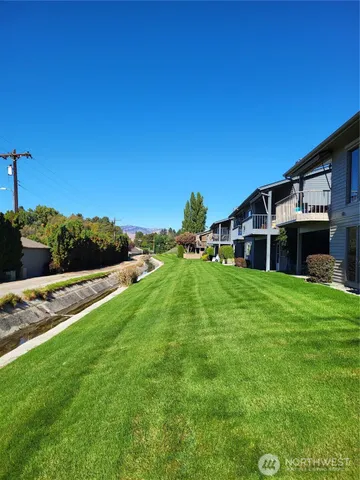 a view of a backyard with sitting area
