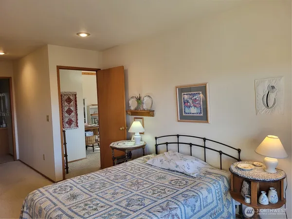 a bedroom with furniture and a large window