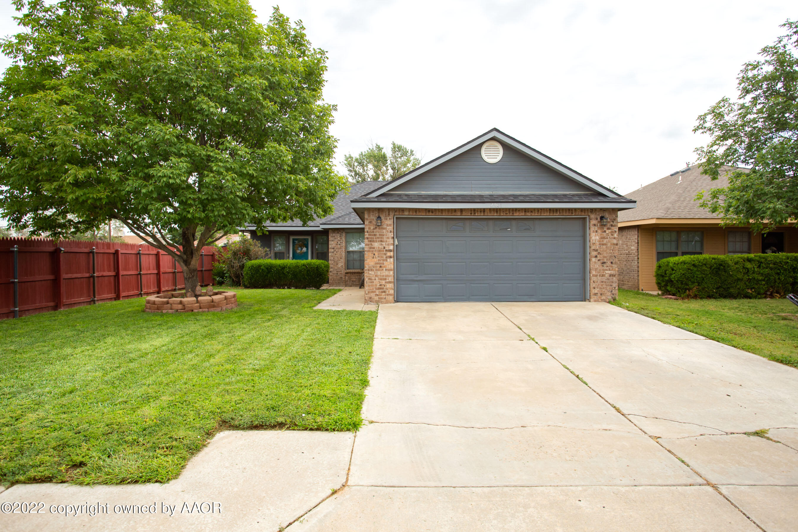 a front view of house with yard garage and green space