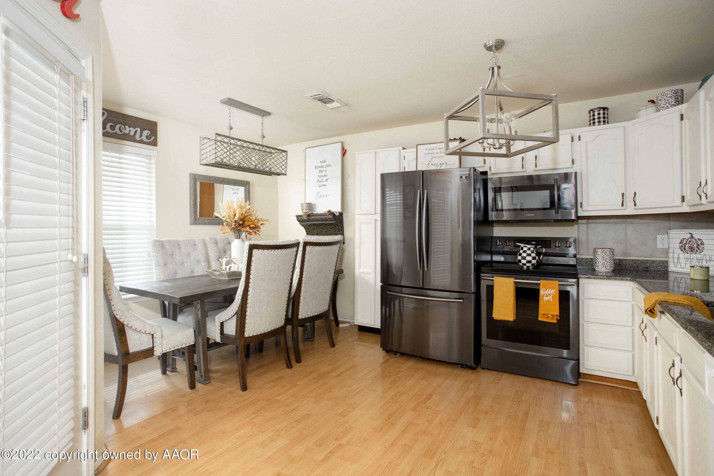 2601 Eagle Point Drive Amarillo, TX 79103 - Photo 4 of 23 a kitchen with stainless steel appliances a refrigerator a stove a sink dishwasher a dining table and chairs