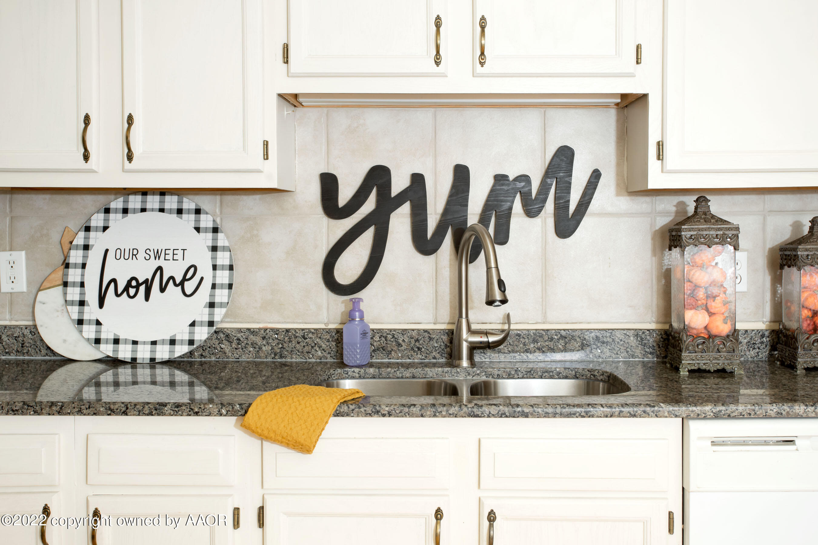 2601 Eagle Point Drive Amarillo, TX 79103 - Photo 7 of 23 a kitchen with kitchen island granite countertop a sink and a white wooden cabinets