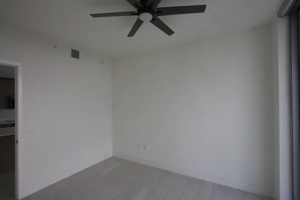 a living room with couches and a dining table with painted walls