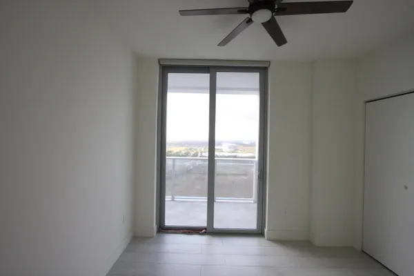 a living room with furniture and a floor to ceiling window