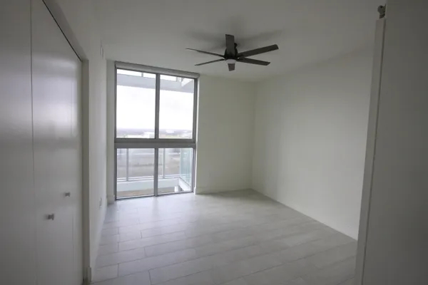 a view of a balcony with chairs and a stove