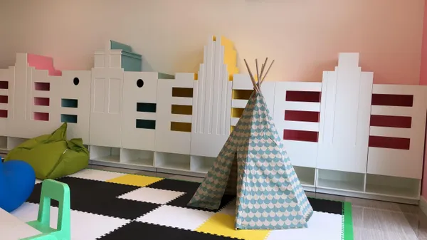 a view of a room that has a window and a table in it