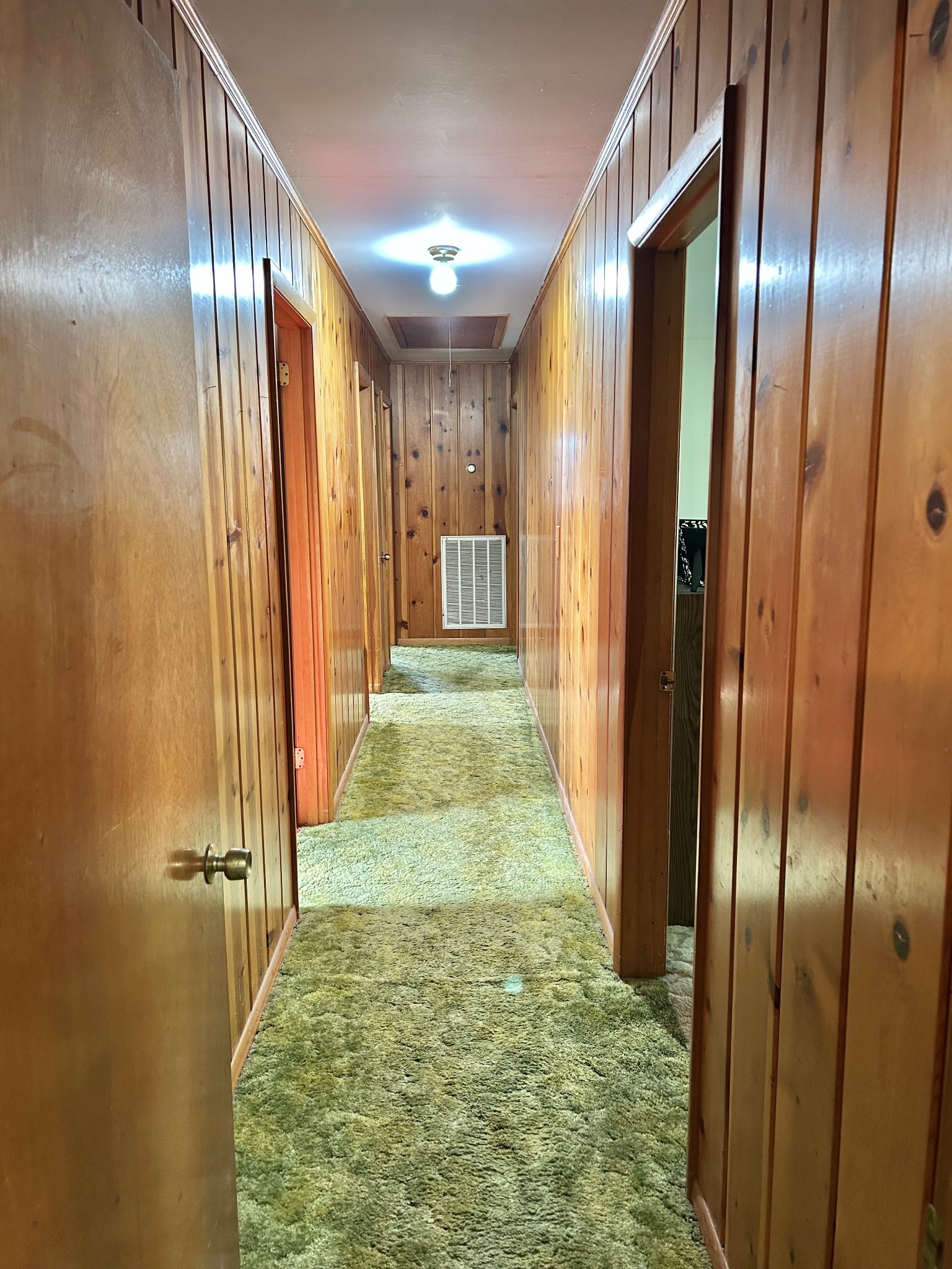1110 Pomroy Road Manchester, TN 37355 - Photo 33 of 55 a view of a hallway with wooden floor and a bathroom