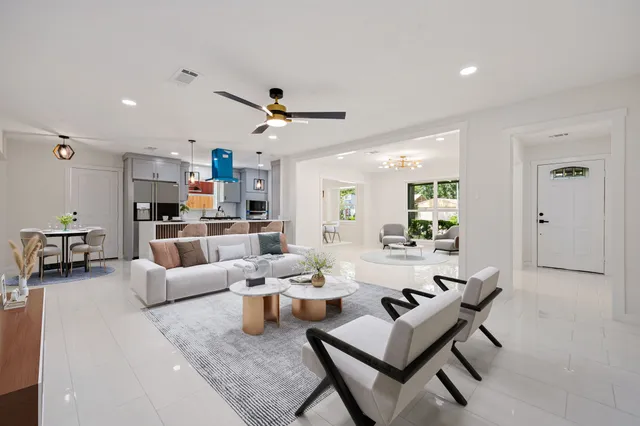 a living room with furniture and kitchen view