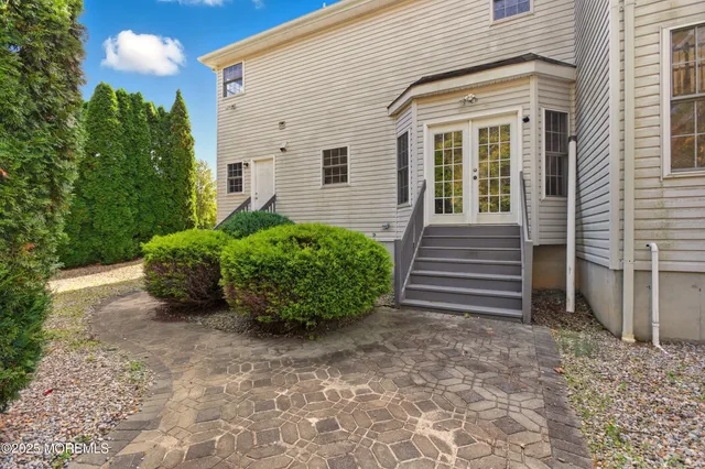 a view of a white house with a yard