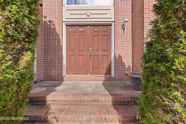 a view of an entryway with wooden floor