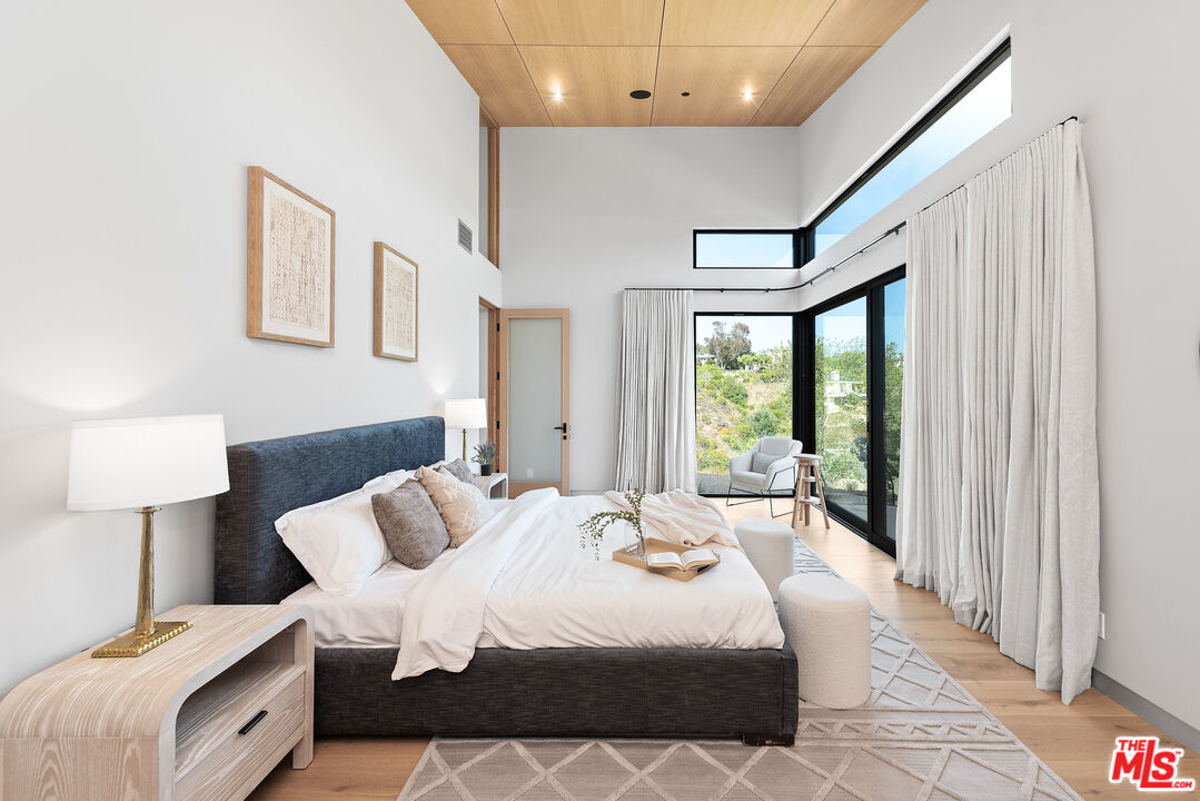 6756 Wandermere Road Malibu, CA 90265 - Photo 12 of 27 a bedroom with a large bed and a large window