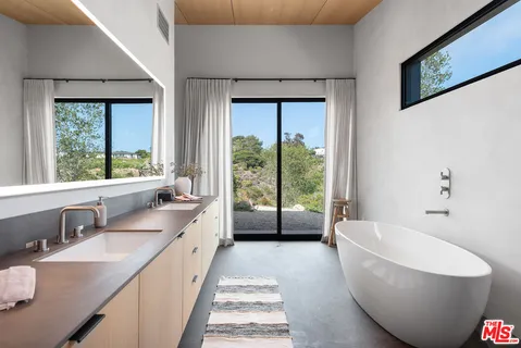 a spacious bathroom with a bathtub and sink