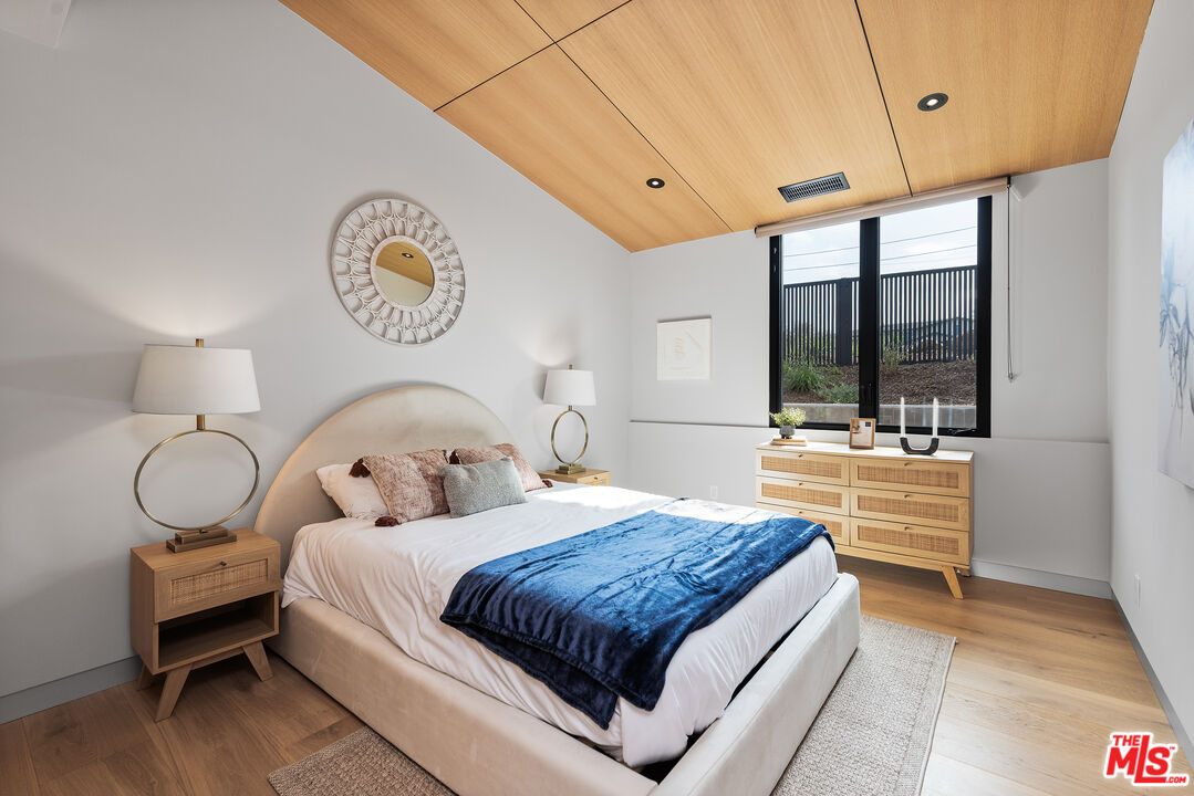 6756 Wandermere Road Malibu, CA 90265 - Photo 15 of 27 a bedroom with a bed and a large window