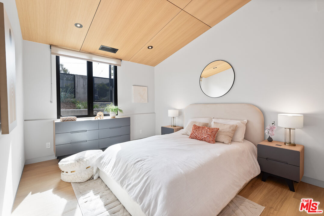 6756 Wandermere Road Malibu, CA 90265 - Photo 16 of 27 a bedroom with a bed and a large window