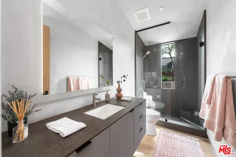 a bathroom with a sink double vanity granite and a mirror