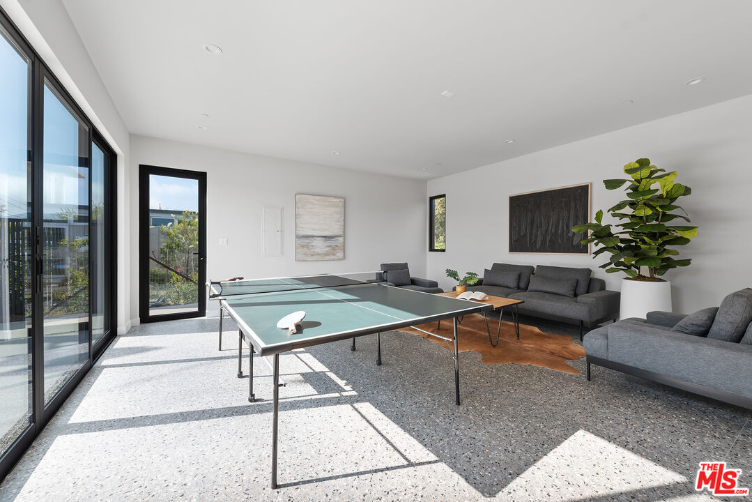 6756 Wandermere Road Malibu, CA 90265 - Photo 19 of 27 a living room with furniture rug and window