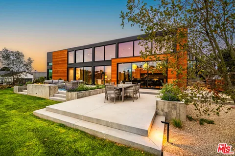 a view of swimming pool with outdoor seating and a patio