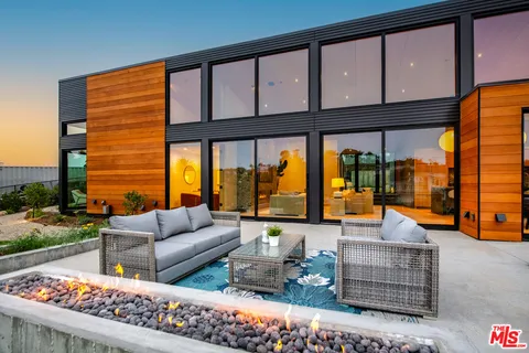 a outdoor living space with patio furniture and a fireplace