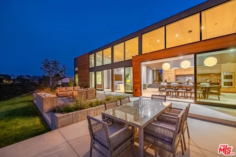 a dining room with furniture and garden view