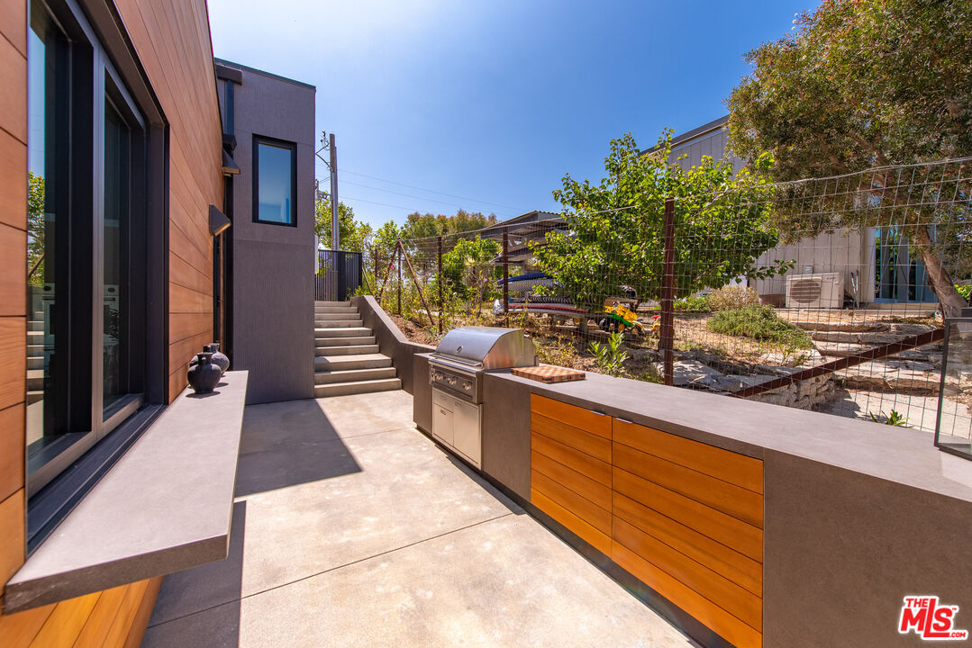 6756 Wandermere Road Malibu, CA 90265 - Photo 24 of 27 a view of a house with many windows