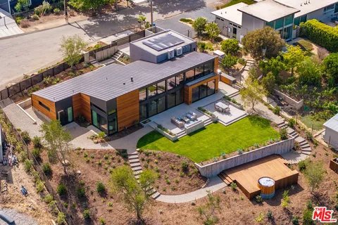 an aerial view of a house with a yard