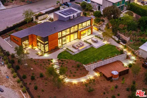 an aerial view of a house with a yard