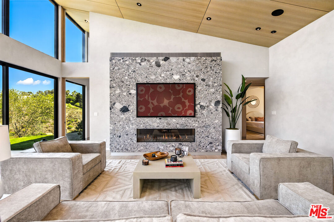 6756 Wandermere Road Malibu, CA 90265 - Photo 6 of 27 a living room with furniture and a fireplace