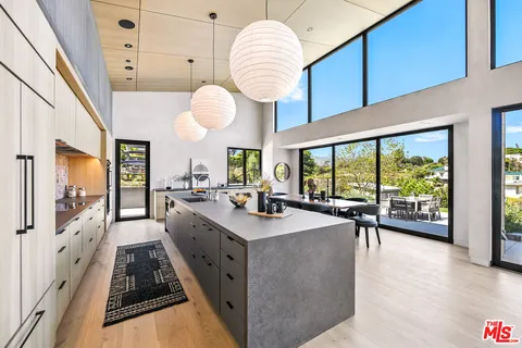 a very nice looking open kitchen with a large window