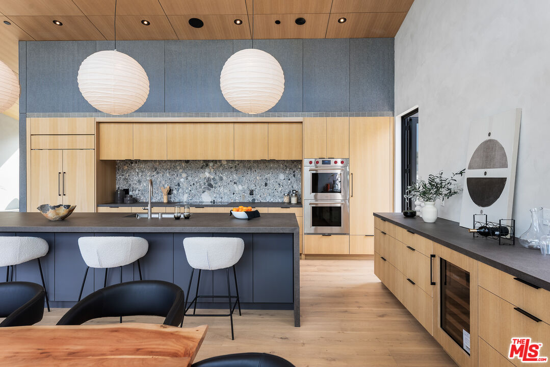 6756 Wandermere Road Malibu, CA 90265 - Photo 9 of 27 a kitchen with a table and chairs