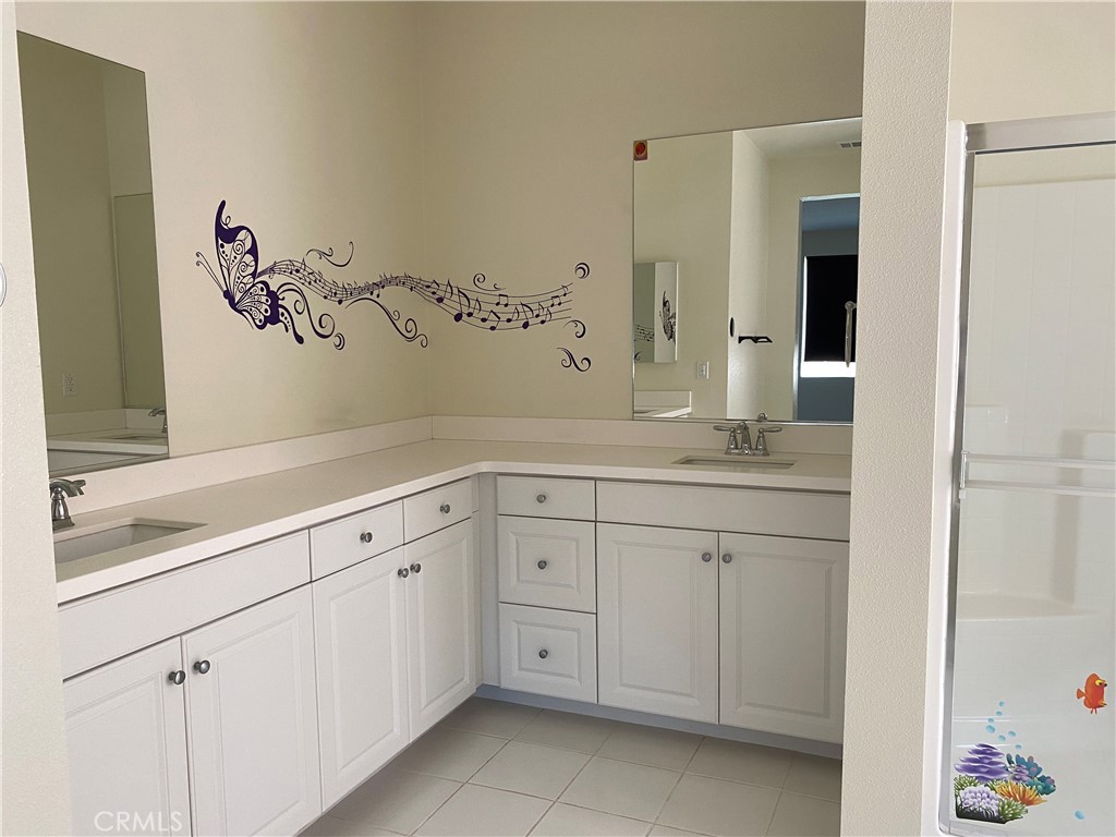 4232 West Ivesbrook Street Lancaster, CA 93536 - Photo 12 of 33 a bathroom with a sink and a mirror