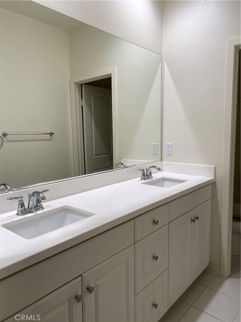 4232 West Ivesbrook Street Lancaster, CA 93536 - Photo 25 of 33 a bathroom with a sink and a mirror