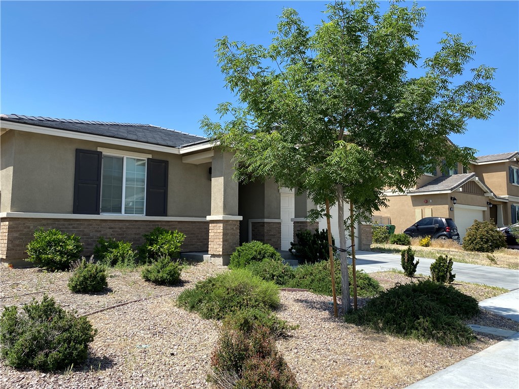 4232 West Ivesbrook Street Lancaster, CA 93536 - Photo 29 of 33 a front view of a house with garden