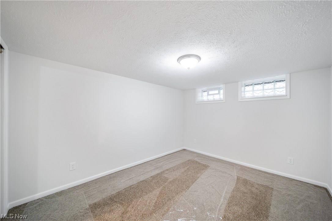 684 Sterling Road Wickliffe, OH 44092 - Photo 28 of 35 Spare room featuring dark colored carpet and a textured ceiling