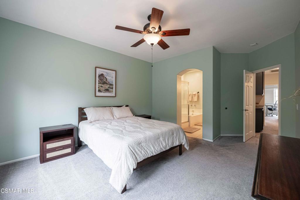 580 Fenwick Way, Unit C Simi Valley, CA 93065 - Photo 22 of 39 a spacious bedroom with a bed and a chandelier