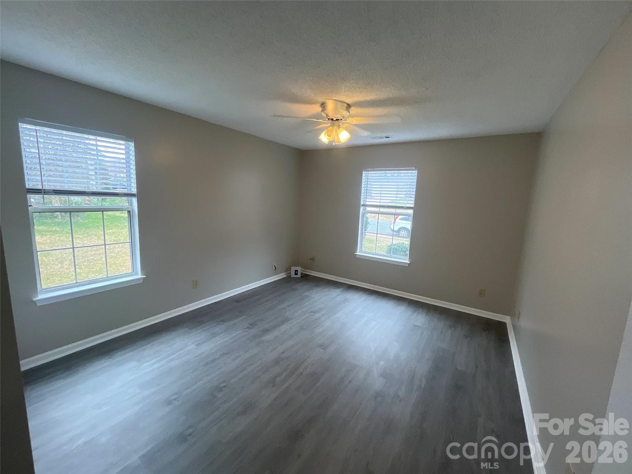 12042 Mallard Ridge Drive Charlotte, NC 28269 - Photo 14 of 20 an empty room with wooden floor and windows